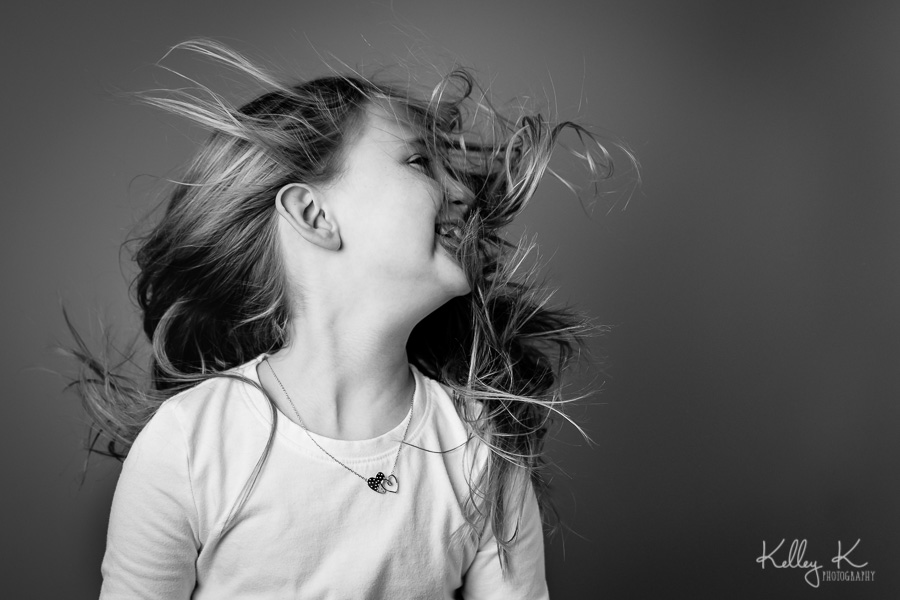 Girl-hair-blowing-studio-black-white-KelleyKPhotography-SmyrnaGA