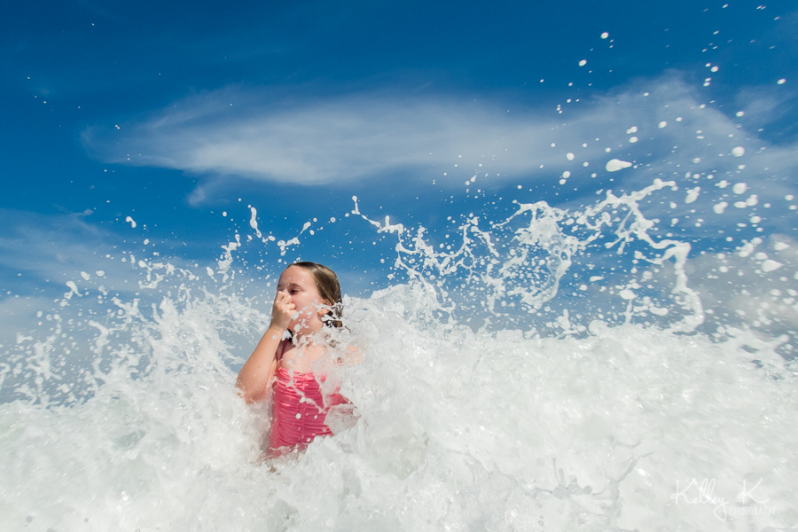 Girl-splashing-ocean-waves-KelleyKPhotography-SmyrnaGA
