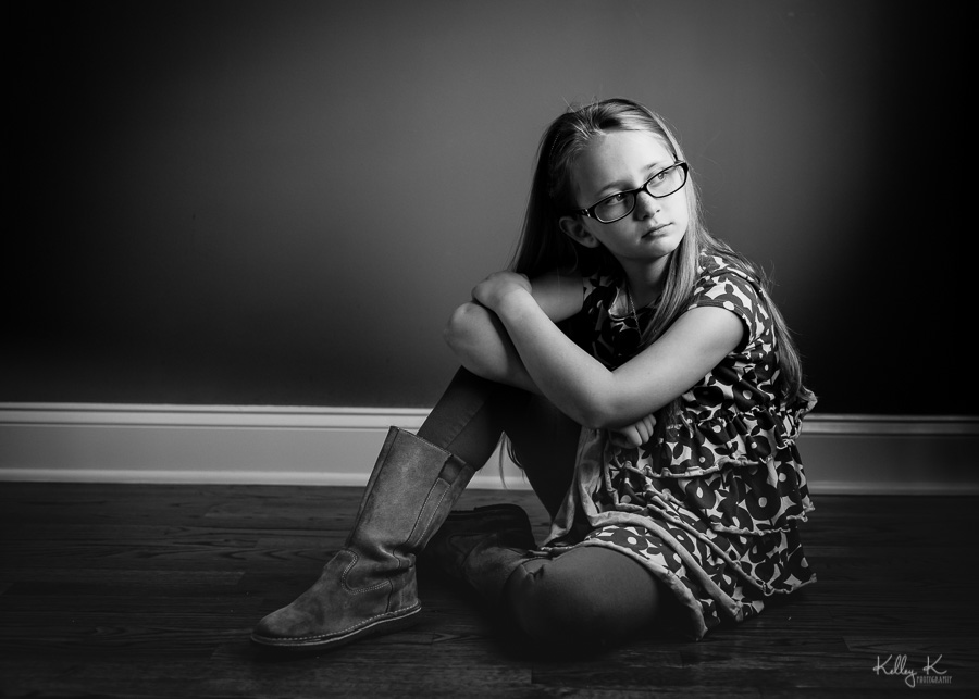Black and white image of girl in directional window light