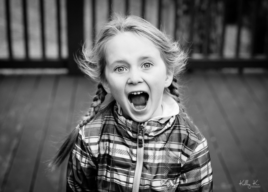 Black and white image of a girl shouting in excitement