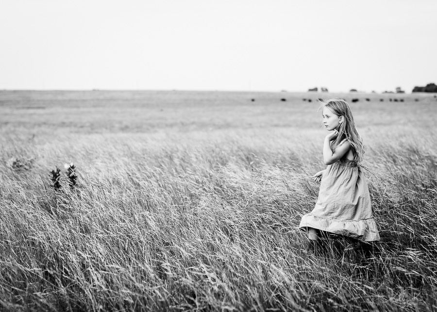 Timeless black and white image of a girl in a field of grain